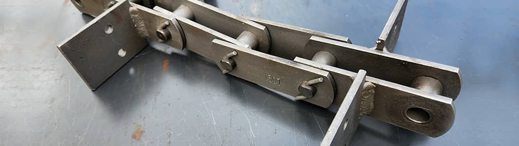 cadenas industriales metalicas utilizadas en maquinaria y sistemas de transporte para procesos productivos